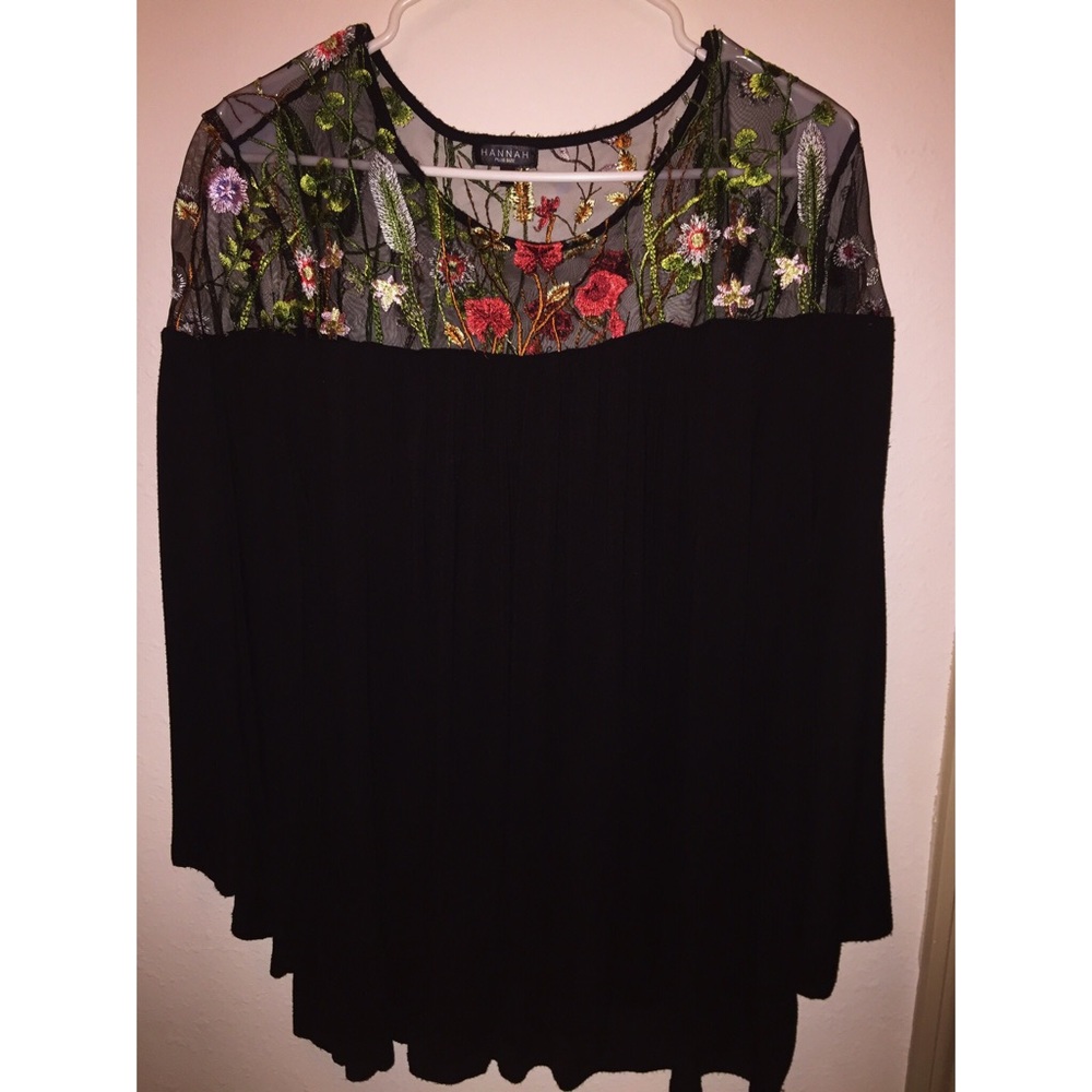 Flowing black blouse with floral embroidery